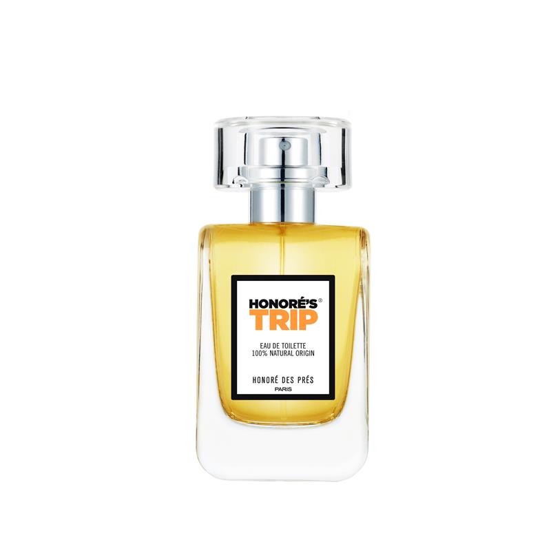 Honoré's Trip Eau de Toilette – transparente Sprayflasche mit silbernem Verschluss, weißem Etikett und gelbem Inhalt, weißer Hintergrund – Parfüm