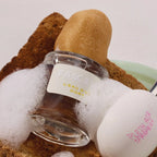 Fascinate L'eau D'or Dort Eau de Parfum – clear glass bottle with white label, surrounded by foam – perfume