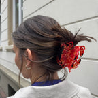 Rote marmorierte Haarklammer Krabbe im Haar einer Frau vor hellem Hintergrund, Haarstyling
