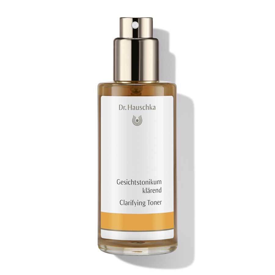 Dr. Hauschka Gesichtstonikum klärend – braune Glasflasche mit Sprühkopf, weißem Etikett und orangefarbenem Streifen – Hautpflege