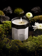 [atype] Scented Candle Pure Rebirth – black candle container 130g, burning on moss, dark background – aromatherapy