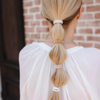 Plastic Free Round Hair Ties Golden Fibres – blonde hair in ponytail, brick background – hair care