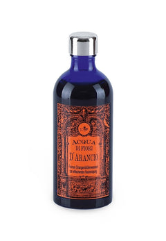 Acqua di Fiori D'Arancio – dunkelblaue Glasflasche mit silbernem Deckel, weißer Hintergrund – Gesichtswasser