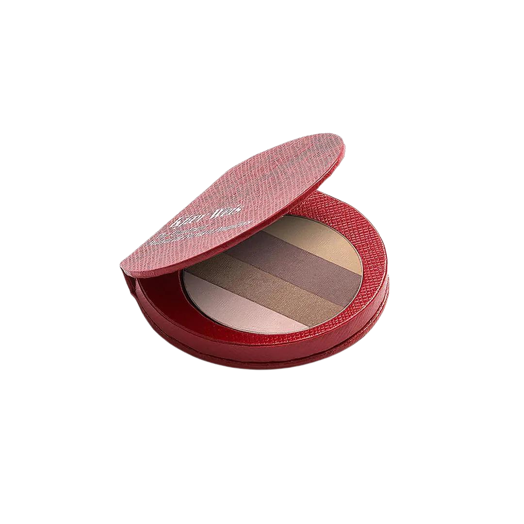 Red Edition Quadrant – runde rote Puderdose mit mehrfarbigem Highlighter, weißer Hintergrund – Make-up