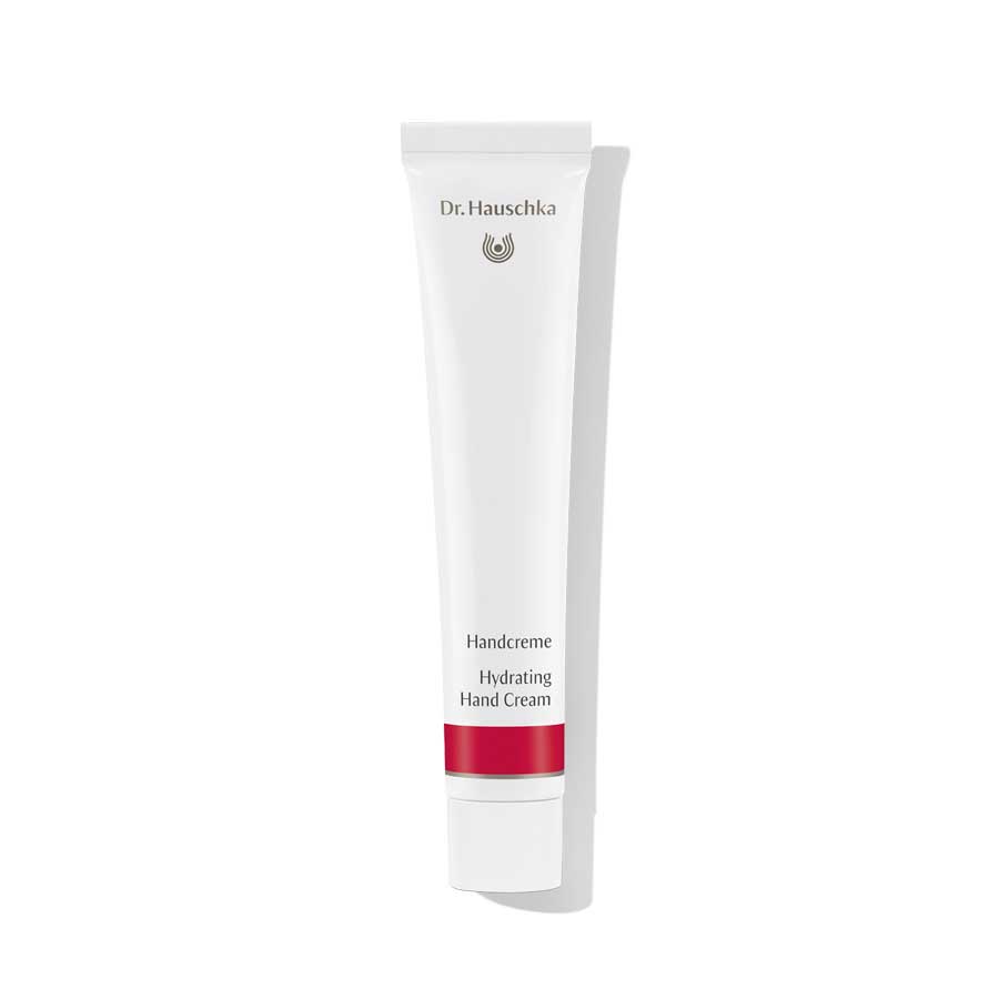 Dr. Hauschka Handcreme – weiße Tube mit rotem Streifen, weißem Deckel, weißem Hintergrund – Hautpflege