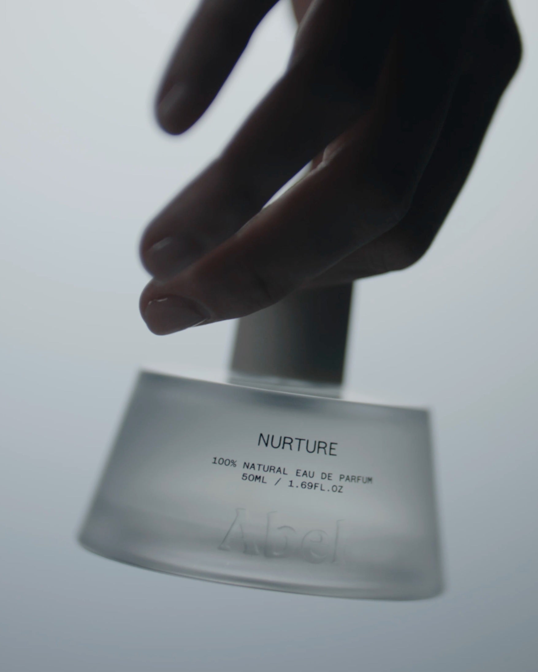 Nurture Eau de Parfum – 50ml glass bottle with spray nozzle, grey-white background – perfume