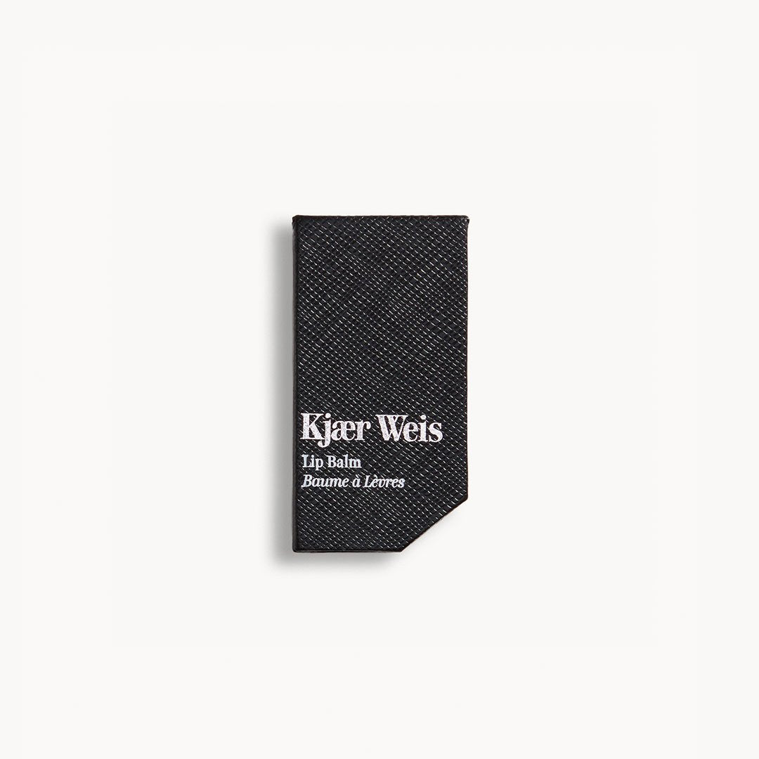 Kjaer Weis Lip Balm – black textured packaging, white background – lip care
