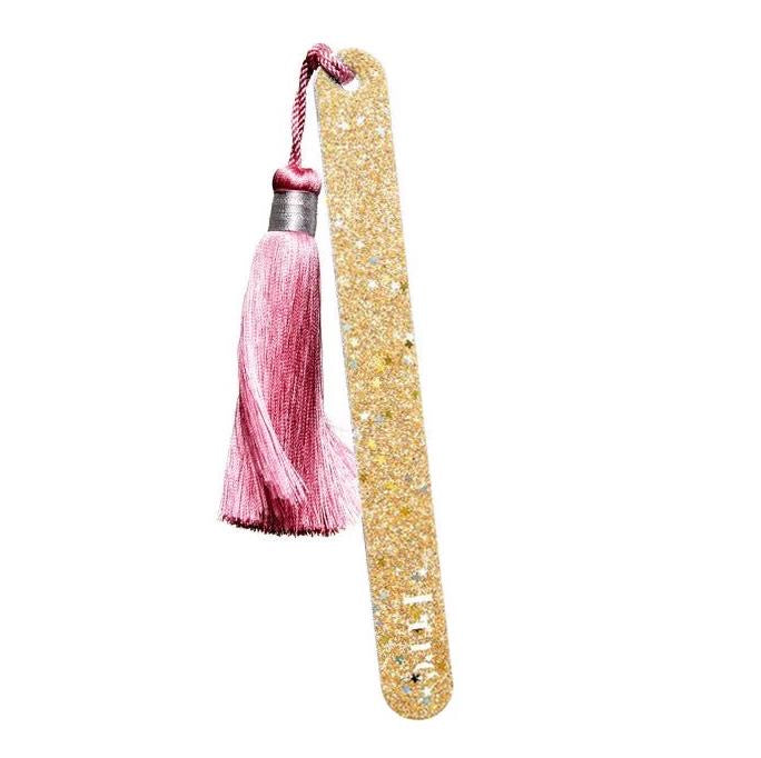 Nail file with pom-pom – gold, pink tassel, white background – nail care