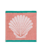Shells Organic Cotton Waschlappen – korallenfarben mit weißer Muschel, türkisrandig, weißem Hintergrund – Gesichtspflege
