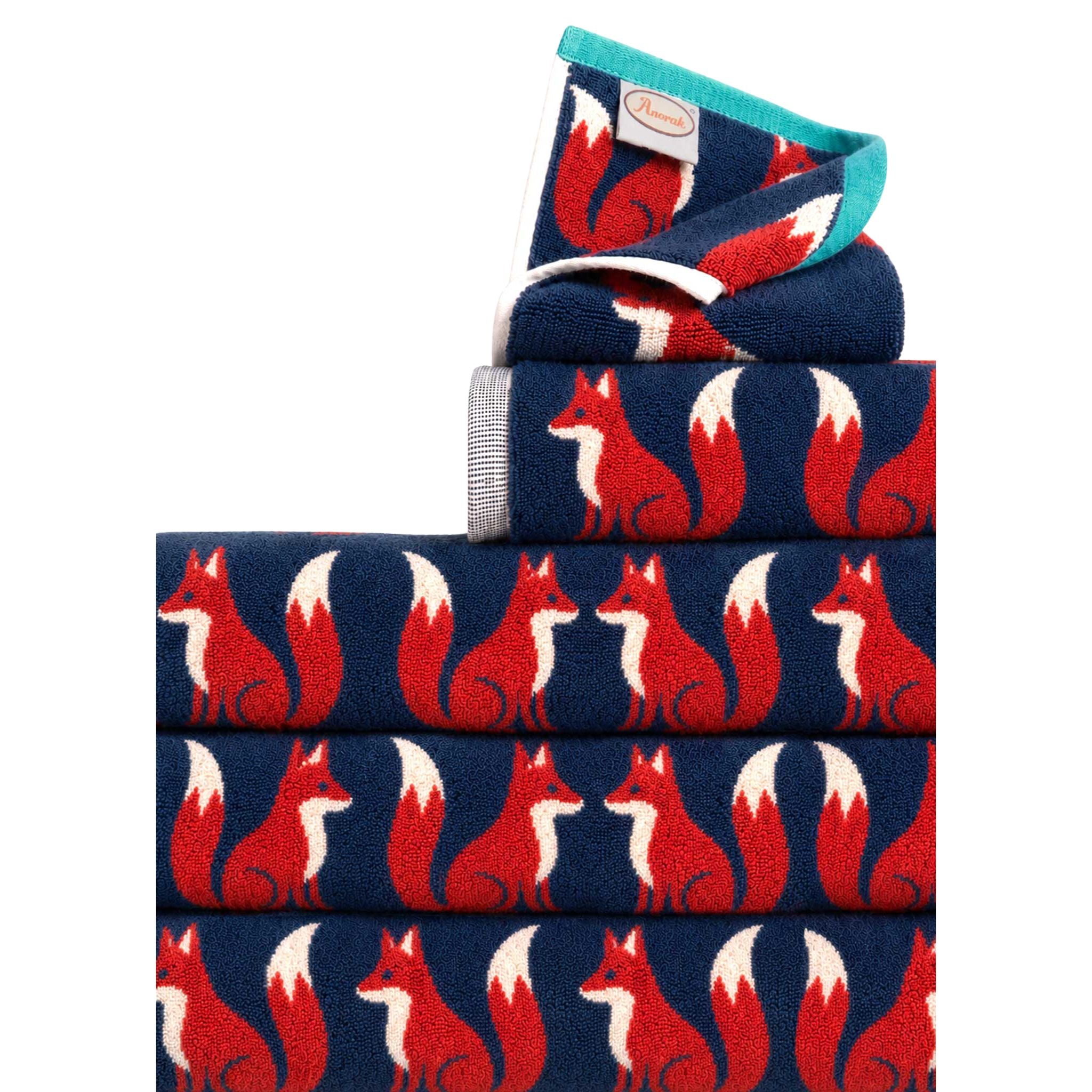 Kissing Foxes organic cotton bath towels in navy blue with red foxes on a white background, bath accessories