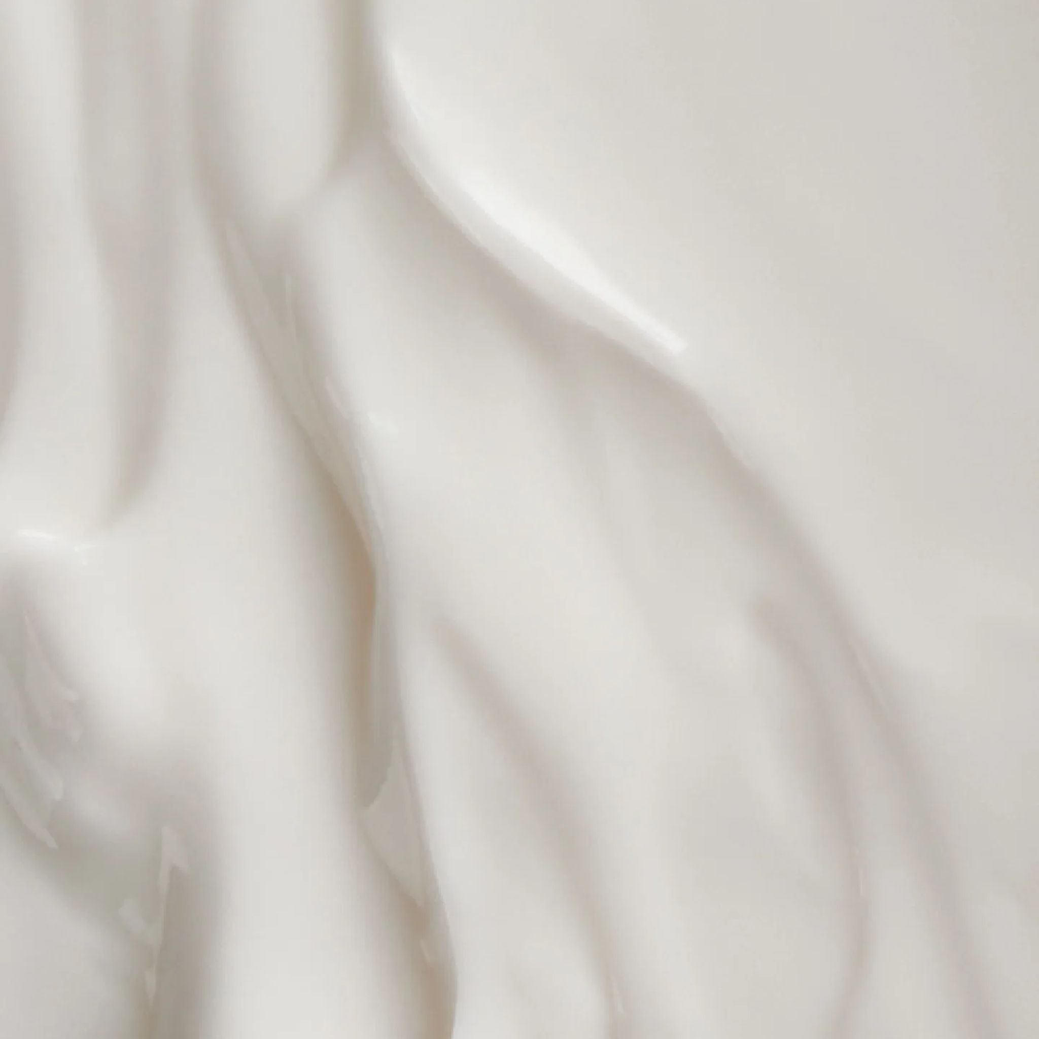 Nahaufnahme der weißen Textur der Grapfruit Körpermilch für die Hautpflege