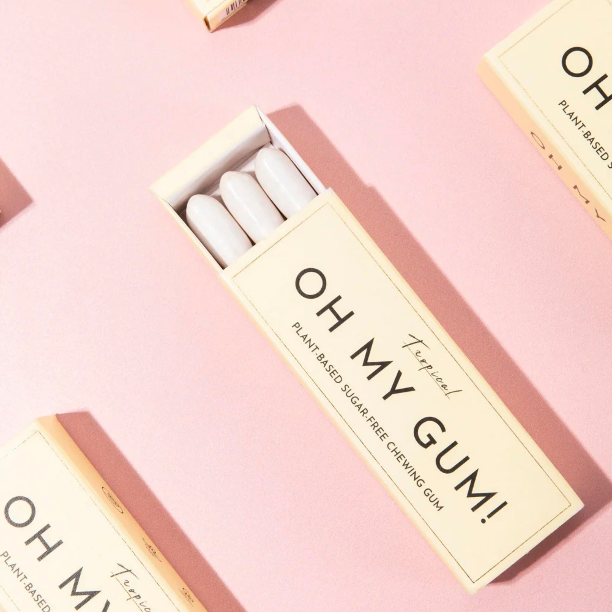 Oh My Gum! plant-based chewing gum in a beige box on a pink background, oral care