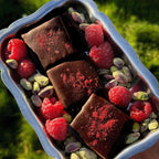 Nut Butter Chocolate Raspberry with pistachio and lion's mane chocolate pieces on a silver tray