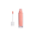 Lip Gloss Treasure Refill in a clear tube with applicator on a white background. Lip care.