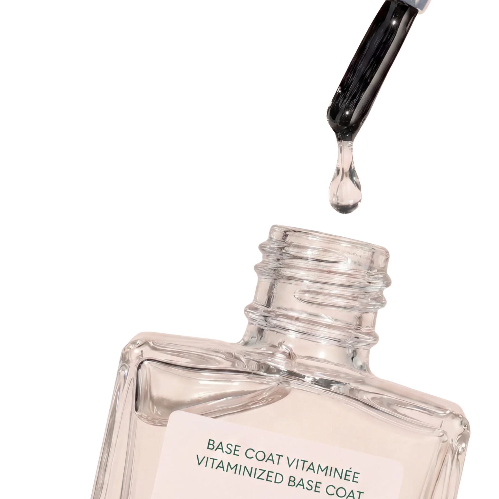 Vitaminized Base Coat in a clear glass bottle with a brush applicator on a white background, nail care.